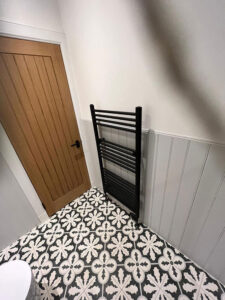 bathroom with patterned floor tiles