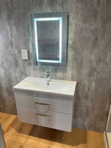 a light-up LED mirror and a wall-hung vanity sink unit