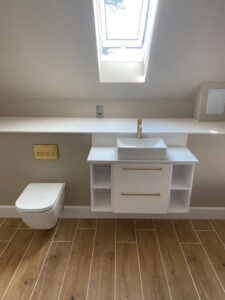Floating toilet and sink with gold fixtures