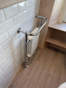column-type tower radiator with a chrome towel rail