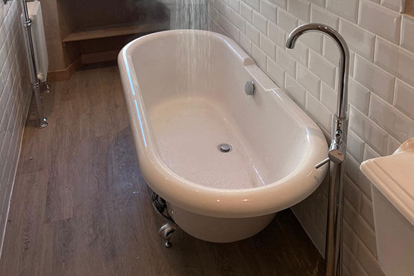 Freestanding Victorian bath with chrome feet, complete with a freestanding bath tap